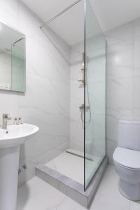 a bathroom with a shower and a toilet and a sink at Hotel West Way in Kutaisi