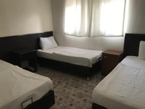 Кровать или кровати в номере KARADUT PENSION NEMRUT