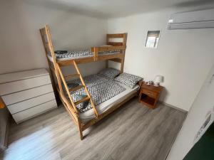 two bunk beds in a room with a wooden floor at Hostel Piran in Piran