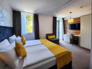 a hotel room with a large bed and a desk at Hotel Bor in Krk