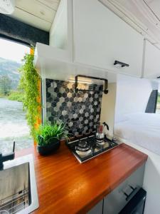 a kitchen with a stove in a tiny house at BeeVan in Aguadilla