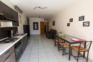 a kitchen and living room with a table and chairs at Mer et calme in Le Pradet