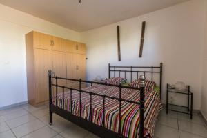 a bedroom with a black bed with a striped blanket at Mer et calme in Le Pradet +38 photos