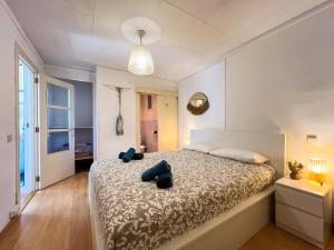 a bedroom with a bed with blue shoes on it at Vivalidays Albert - Calella - in Calella