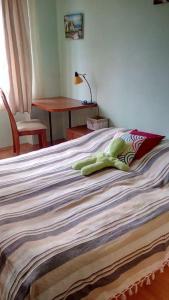 a bed with a green towel on top of it at Apartment Letna near the city center in Košice