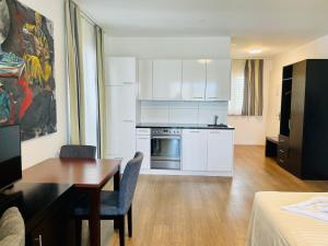 a kitchen with a table and a dining room at Hotel Swiss Bellevue in Kreuzlingen