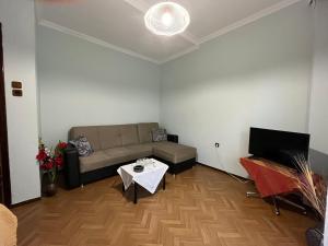 a living room with a couch and a table at Sofi’s Apartment in Kavála