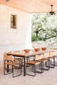 a wooden table and chairs with bowls on it at Contigo Ranch Fredericksburg in Fredericksburg