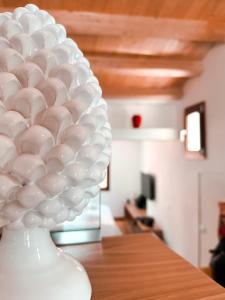 a white vase sitting on top of a table at AWA Cefalù Bordonaro in Cefalù