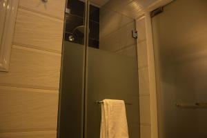 a shower with a glass door and a towel at "Chez Riche" Luxury serviced apartment 12 in Cairo