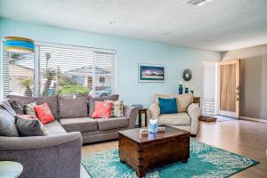 a living room with two couches and a coffee table at Verdon Oasis in Morro Bay