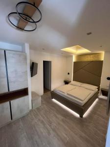 a large bedroom with a bed and a chandelier at H&H Rooms Rovinj - Adults Only in Rovinj