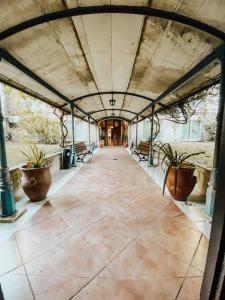 an empty hallway with potted plants in a building at Posada de San Isidro in San Isidro