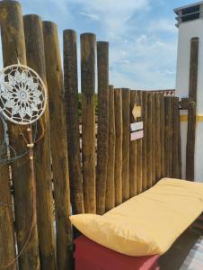 a bench in front of a wooden fence at Casa Xara in Proença-a-Nova