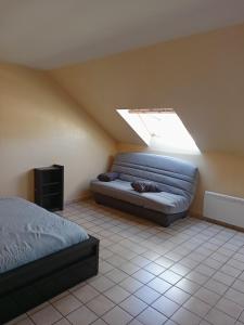 a bedroom with a bed and a skylight at MARGUERITE in Massiac