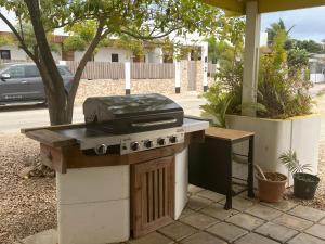 a grill sitting on a patio with a table at Diver's Paradise Bonaire in Kralendijk