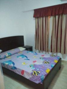 una camera da letto con un letto con un piumone colorato di شاليه بقرية كورنادو السخنه a Ain Sokhna