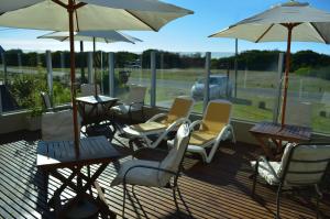 a group of chairs and umbrellas on a deck at Arenas del Este in Costa del Este +16 photos