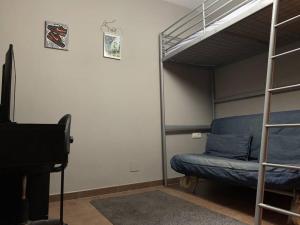a bedroom with a bunk bed and a couch and a piano at Villa costa del sol in Torremolinos