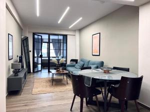 a living room with a table and a couch at Modiano Luxury Apartment Thessaloniki in Thessaloniki
