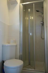 a bathroom with a toilet and a glass shower at Modern Apartment Ayr Town Centre in Prestwick