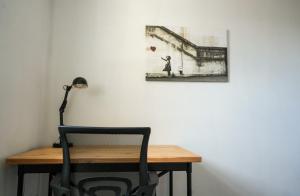 a desk with a chair and a painting on the wall at Modern Apartment Ayr Town Centre in Prestwick