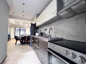 a kitchen with a sink and a counter top at Modiano Luxury Apartment Thessaloniki in Thessaloniki