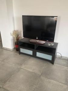a black entertainment center with a flat screen tv at Artemis House in Nea Fokea