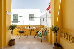 a small balcony with a table and chairs at NaxosAir1 in Naxos Chora