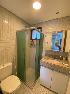 a bathroom with a shower and a toilet and a sink at Ekoara Residence - Muro Alto in Porto De Galinhas