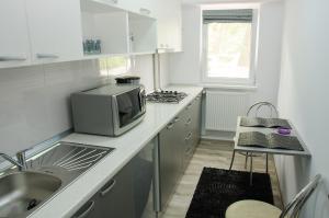 a kitchen with a sink and a microwave on a counter at Apartament Salcia in Galaţi