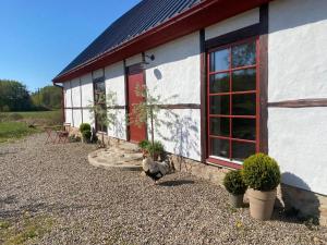 a house with two chickens sitting outside of it at Rönnebröd Guesthouse in Rönnebröd