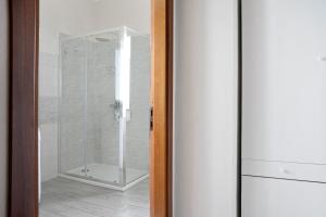 a shower in a bathroom with a glass door at La casa del Pue in Bene Vagienna +13 photos