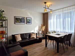 a living room with a couch and a table at City Nest Gdańsk - Komfortowy punkt na mapie Gdańska in Gdańsk
