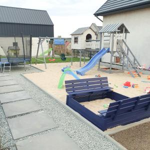 a playground with a bench and a slide at Domki Białe Żagle in Władysławowo
