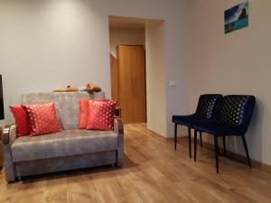 a living room with a couch and two chairs at Apartment Central Park in Daugavpils