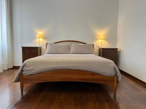 a bedroom with a bed with two night stands and two lamps at Il Grottino Relais & Spa in Gualdo Cattaneo