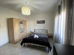 a bedroom with a bed with a teddy bear on it at Sea View House in Kavala