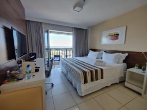 a hotel room with a large bed and a television at Vision otima localização vista incrível e muitas comodidades in Brasilia