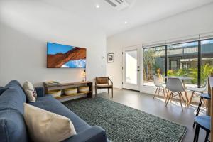 a living room with a blue couch and a table at Unique Design 1-bedroom Apartment - 80 Walkscore! in Phoenix