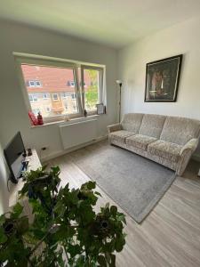 a living room with a couch and a large window at KobyApartment in Herford