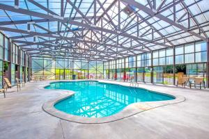 a large indoor swimming pool with a glass ceiling at Hawks Point Lodge, 5 Bedrooms, Sleeps 10, Pool Access, Hot Tub, Pool Table in Sevierville