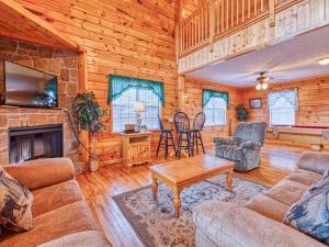 a living room with a couch and a fireplace at Hawks Point Lodge, 5 Bedrooms, Sleeps 10, Pool Access, Hot Tub, Pool Table in Sevierville