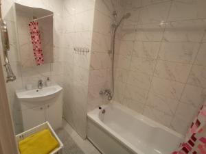 a bathroom with a sink and a tub and a shower at Comfortable apartment in center in Narva