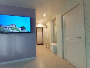 a room with a flat screen tv on a wall at Comfortable apartment in center in Narva