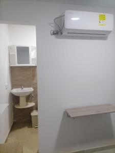 a white bathroom with a sink and a toilet at Edif HA in Cartagena de Indias