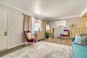 a living room with a blue couch and purple chairs at Single-Story Retreat about 1 Mi to Downtown Tucson! in Tucson