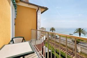 a balcony with a table and a view of the ocean at Monolocale 9 in Borgio Verezzi