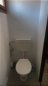 a small bathroom with a white toilet in a stall at Šiška Kemp in Doksy