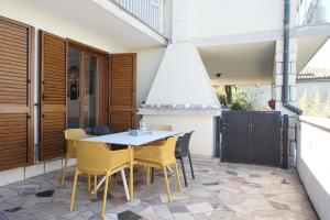a patio with a table and chairs on a balcony at APARTMAJI PRI BOSI NOGI in Izola